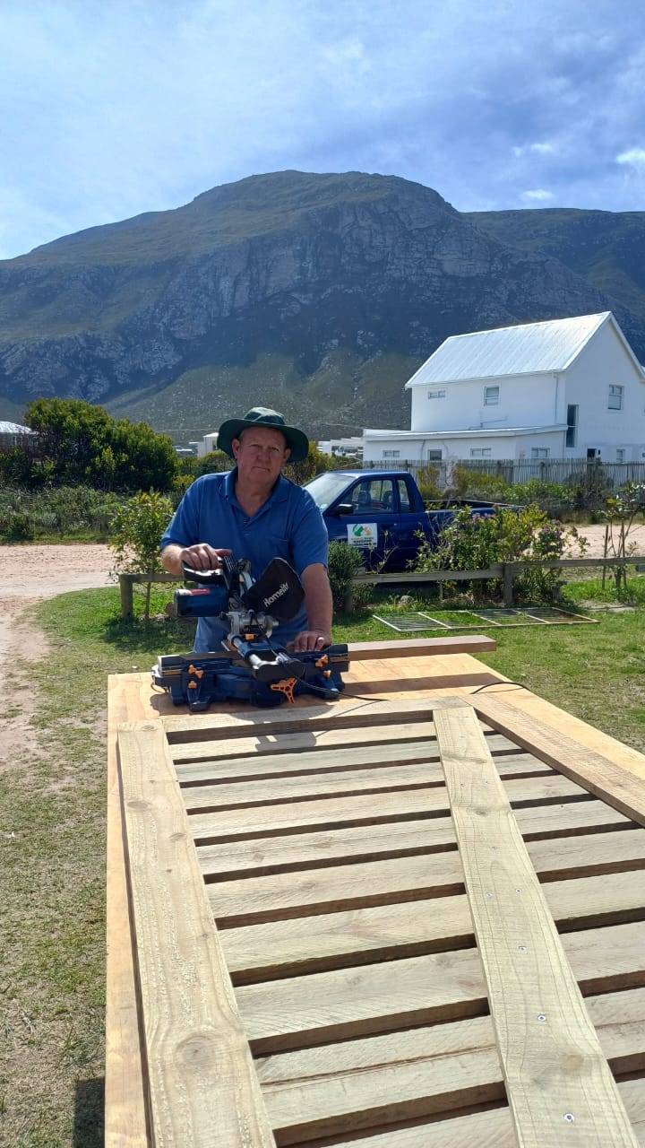 Neville Banwell building deck framing on site